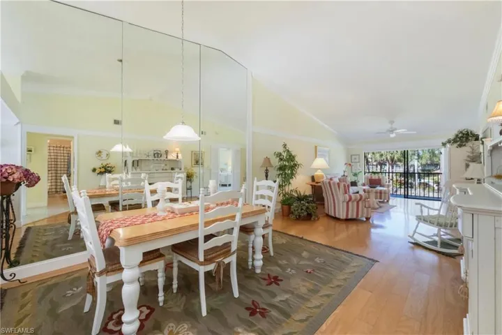 Dining area with vaulted ceiling, light wood-type flooring, and a ceiling fan