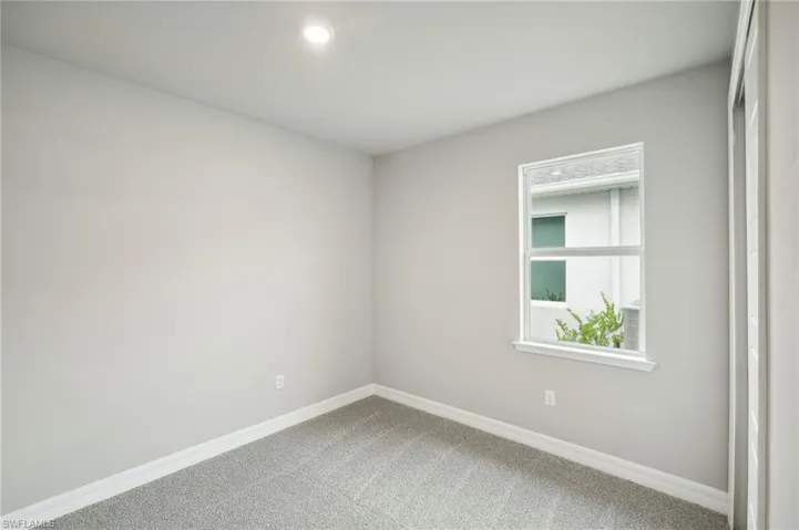 Spare room featuring carpet flooring