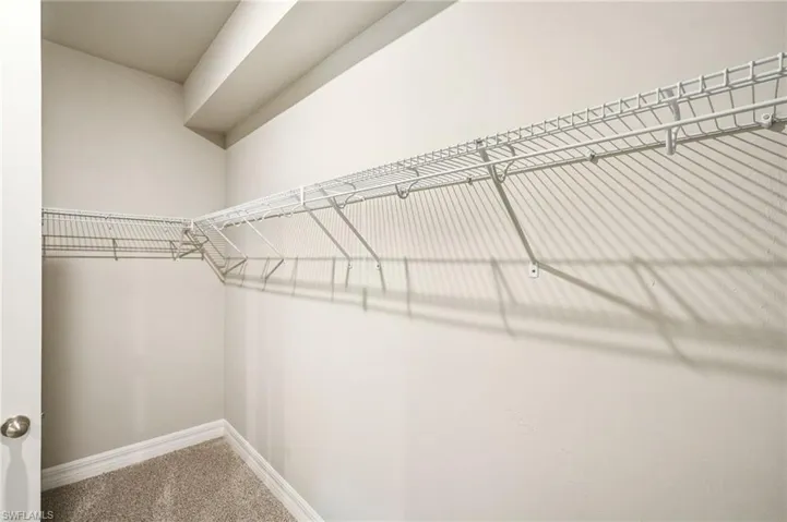 Walk in closet featuring carpet flooring