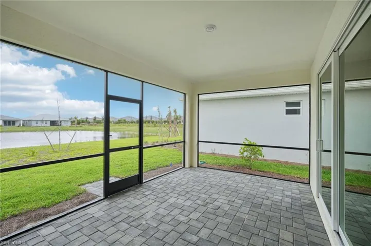 Unfurnished sunroom featuring a water view