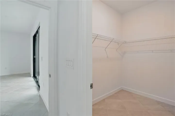 Spacious closet featuring light tile patterned floors