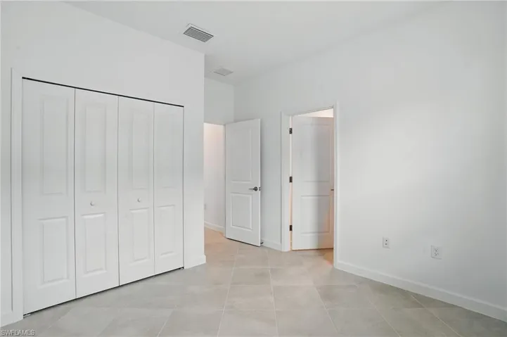 Unfurnished bedroom featuring baseboards and a closet