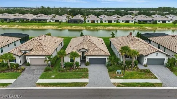 Aerial perspective of suburban area featuring a nearby body of water