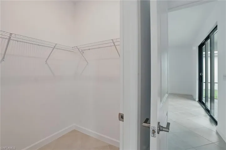 Spacious closet featuring light tile patterned flooring