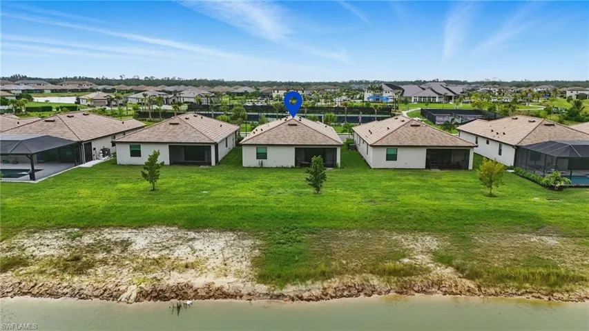 Aerial view of residential area featuring a nearby body of water