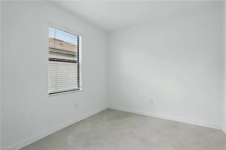 Spare room featuring baseboards