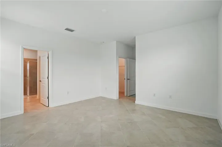 Spare room featuring baseboards