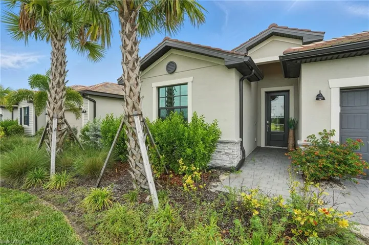 Entrance to property with stucco siding