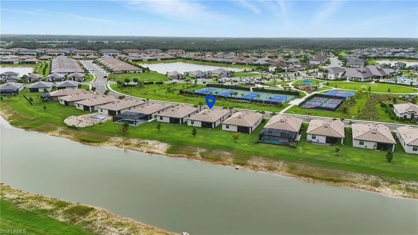 Aerial perspective of suburban area featuring a nearby body of water