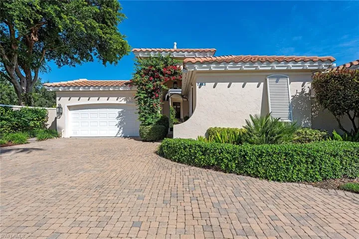 Mediterranean / spanish house featuring stucco siding, decorative driveway, an attached garage, and a tiled roof