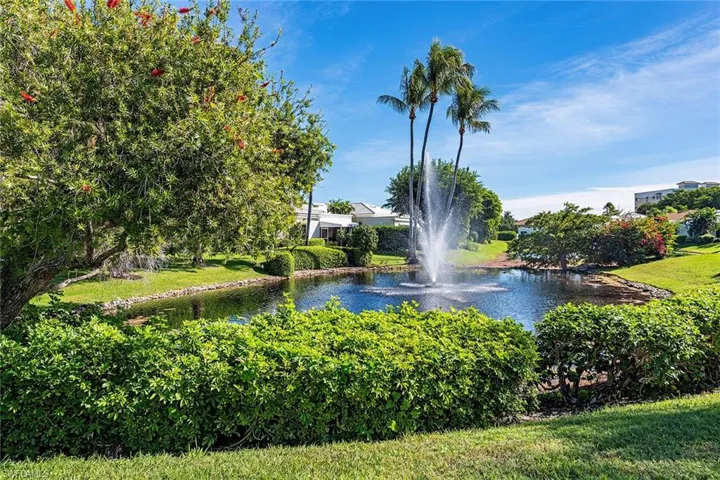 View of community featuring a water view and a yard