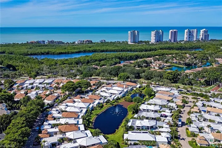 Aerial overview of property's location featuring a nearby body of water and nearby suburban area