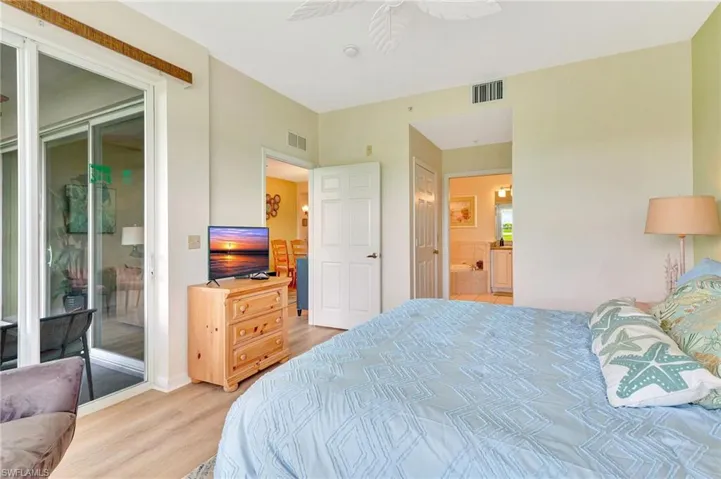 Bedroom featuring ceiling fan, light wood-type flooring, and access to outside