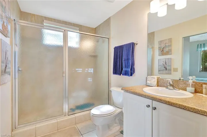 Bathroom featuring plenty of natural light, tile flooring, toilet, and vanity