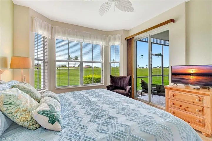 Bedroom with multiple windows and access to exterior