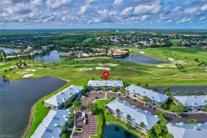 Birds eye view of property with a water view