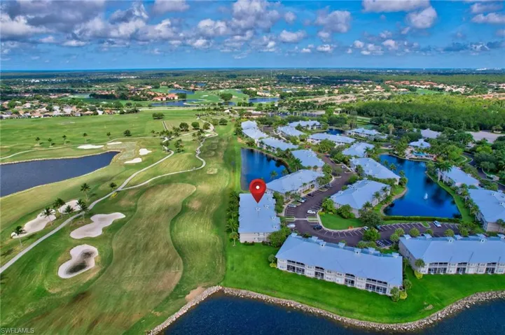 Birds eye view of property with a water view