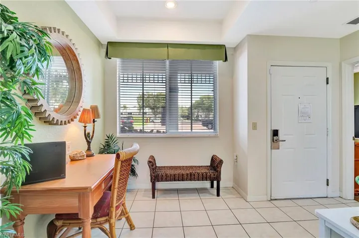 Tiled foyer featuring a raised ceiling