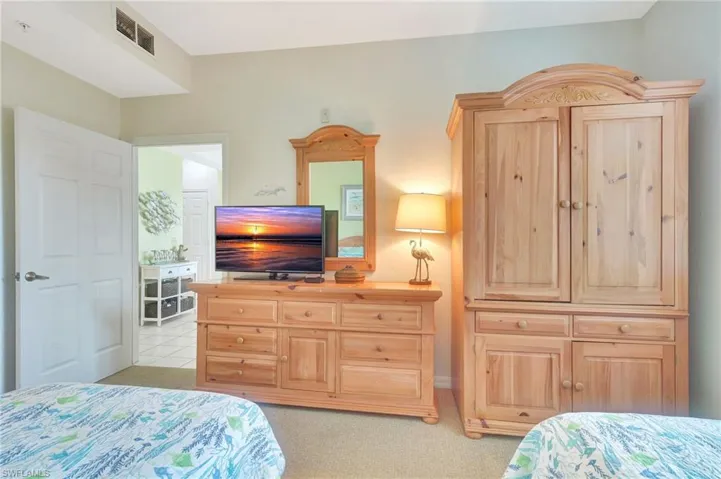 Bedroom featuring light carpet