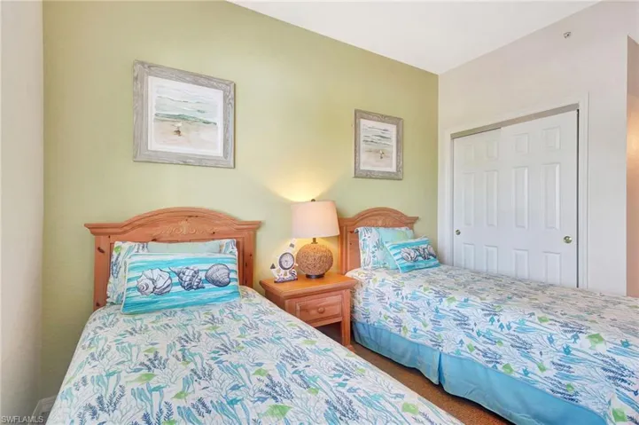 Bedroom featuring carpet and a closet