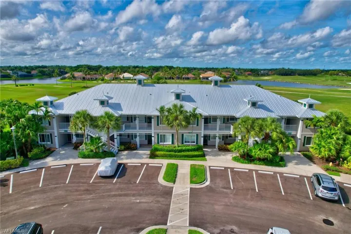 Birds eye view of property with a water view