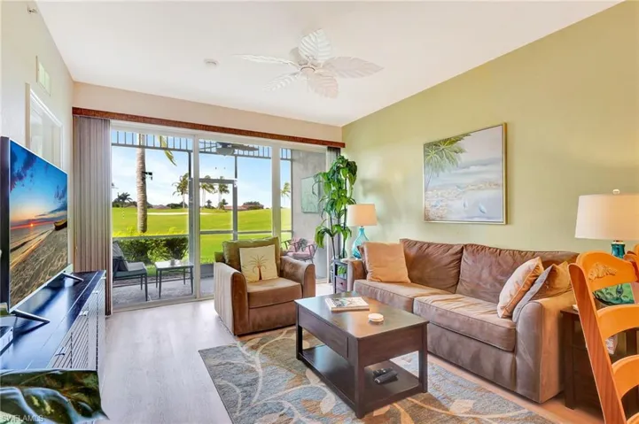 Living room with hardwood / wood-style flooring and ceiling fan
