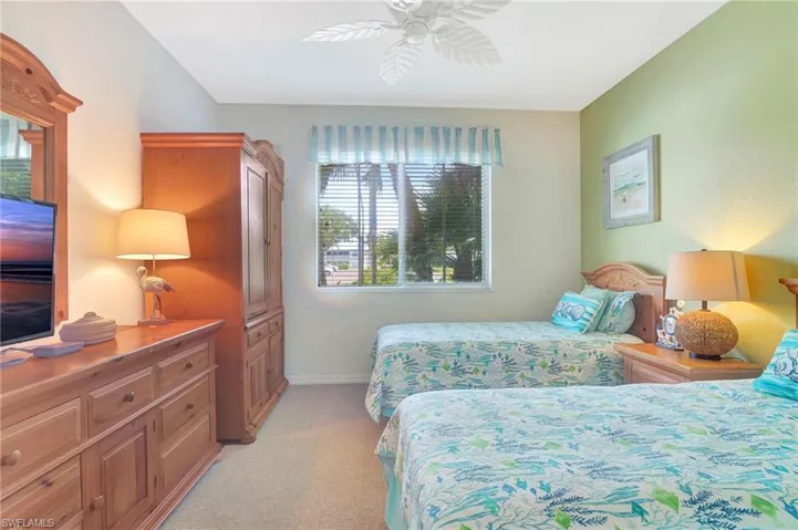 Bedroom with light carpet and ceiling fan