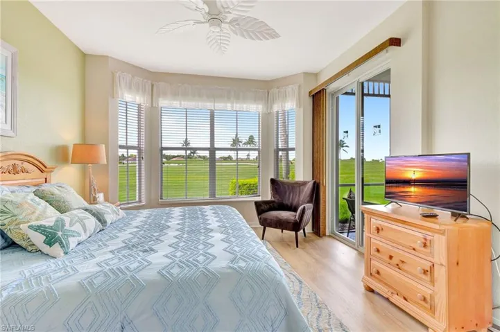 Bedroom featuring access to outside, light wood-type flooring, and ceiling fan