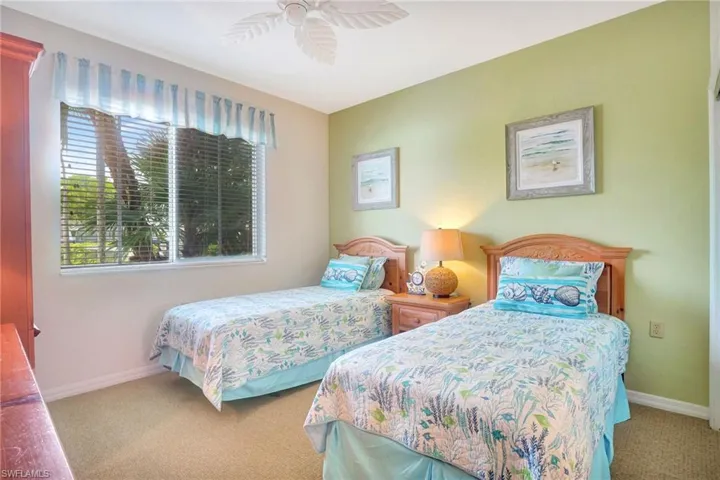 Carpeted bedroom featuring ceiling fan