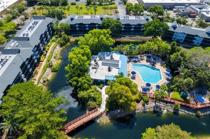 Drone / aerial view of a pool and a large body of water