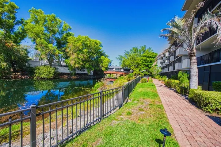 View of property's community featuring fence and a water view