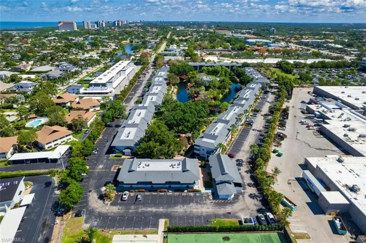 Aerial view of property and surrounding area with a nearby body of water