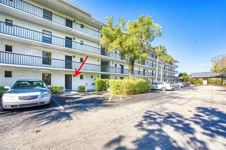 View of property with uncovered parking