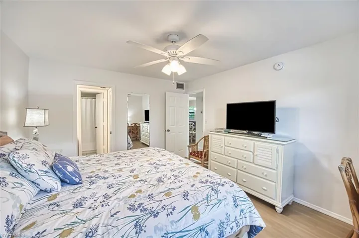 Bedroom with light wood-style flooring, baseboards, and ceiling fan