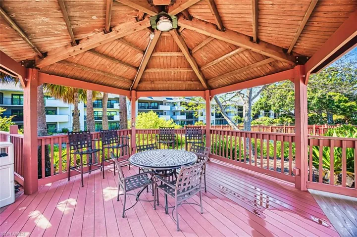 Wooden terrace with a gazebo and outdoor dining space