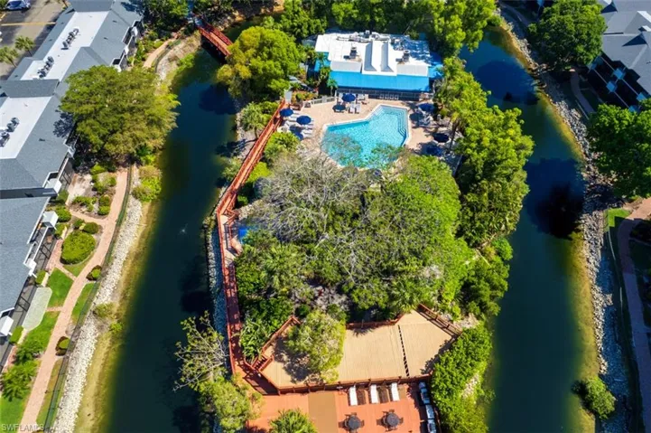 Drone / aerial view of a pool and a large body of water