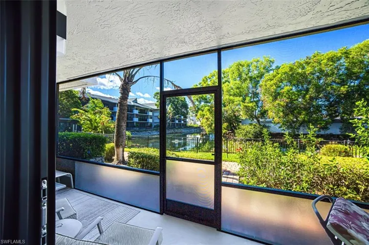 Entryway with floor to ceiling windows and a water view