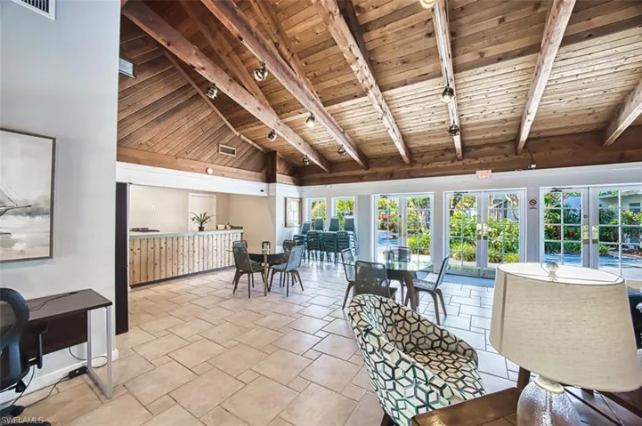 Sunroom / solarium featuring french doors and rail lighting