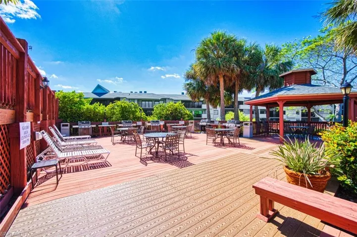 Deck featuring a gazebo and outdoor dining area