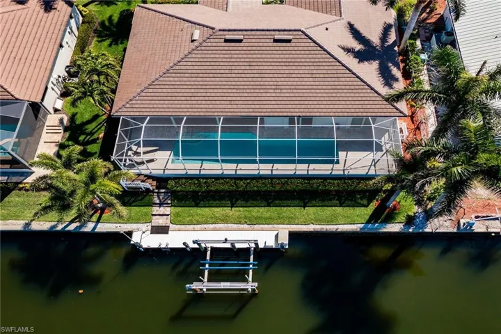 Birds eye view of property with a water view