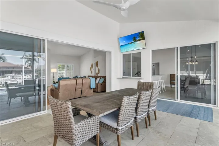 Dining area featuring high vaulted ceiling and a ceiling fan