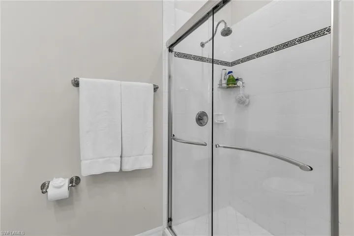 Full bath featuring a shower stall