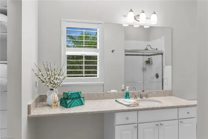 Bathroom with a shower stall and vanity