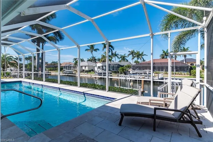 Pool featuring a lanai, a patio area, and a water view