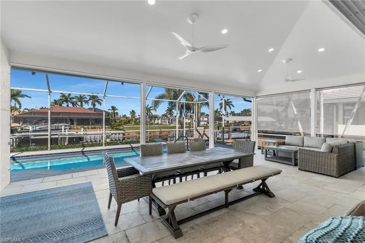 Sunroom featuring vaulted ceiling and a ceiling fan