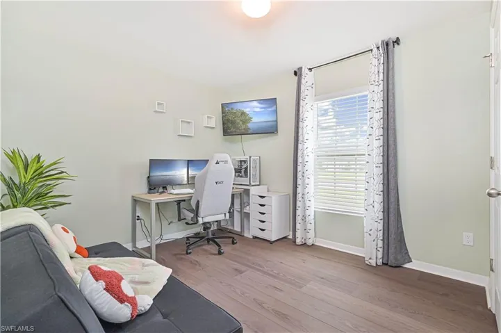 Office with wood finished floors and baseboards