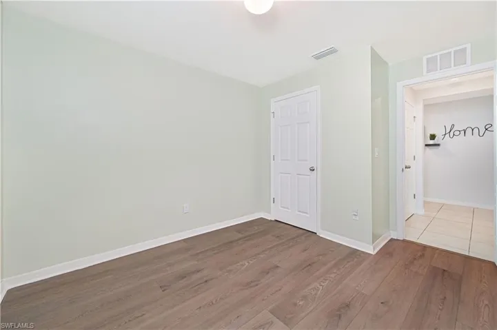 Empty room featuring wood finished floors and baseboards