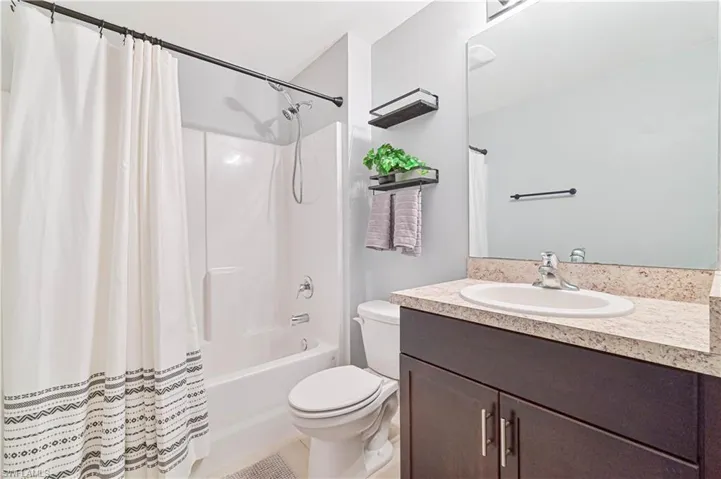 Full bath with vanity and shower / bath combo with shower curtain