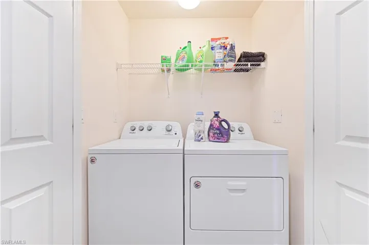 Laundry room featuring washer and clothes dryer