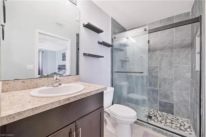 Bathroom with vanity and a shower stall